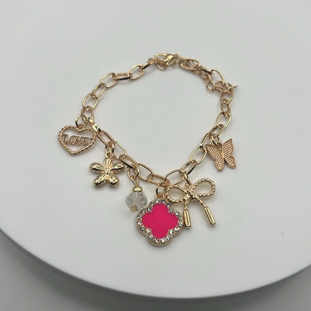849. Gold Charm Bracelet with Pink Accent